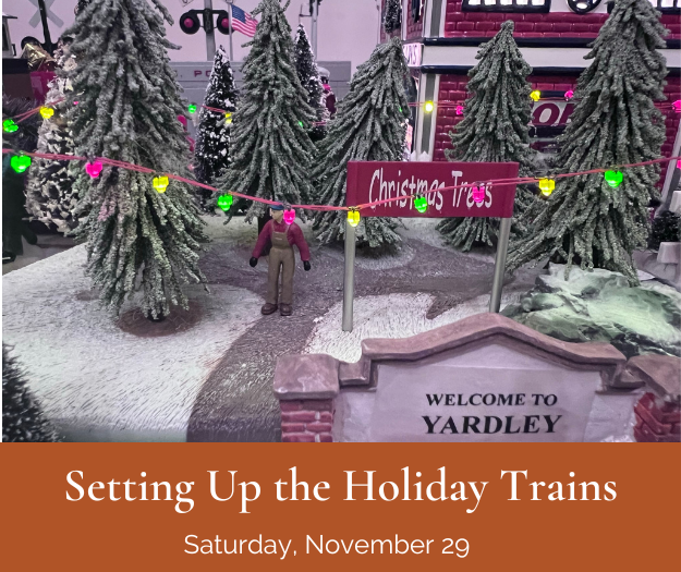 model train layout with welcome sign